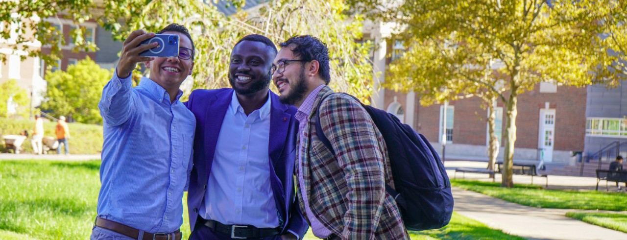 Three international students take a selfie.