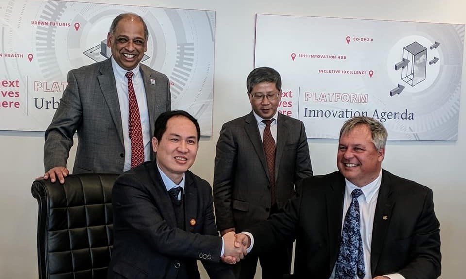 President Neville Pinto welcomes a delegation for an agreement signing with an international partner institution.