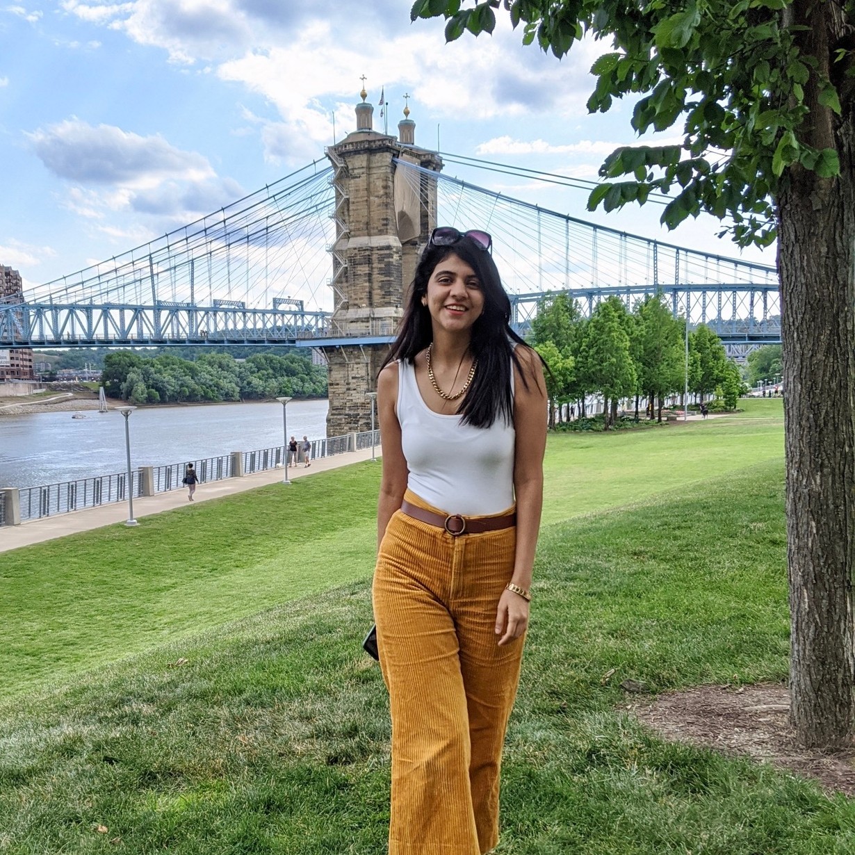 Maitri Sheth strolls in Smale Park in front of the Roebling bridge.