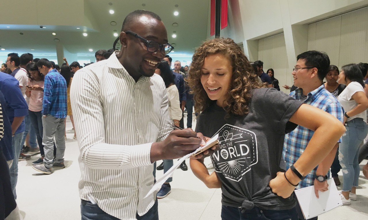 Maria Mallory assists a new international student at campus orientation.